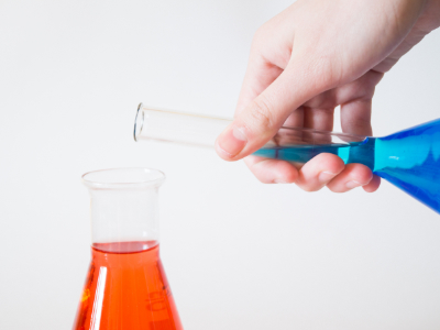 Přelévání modré kapaliny do červené